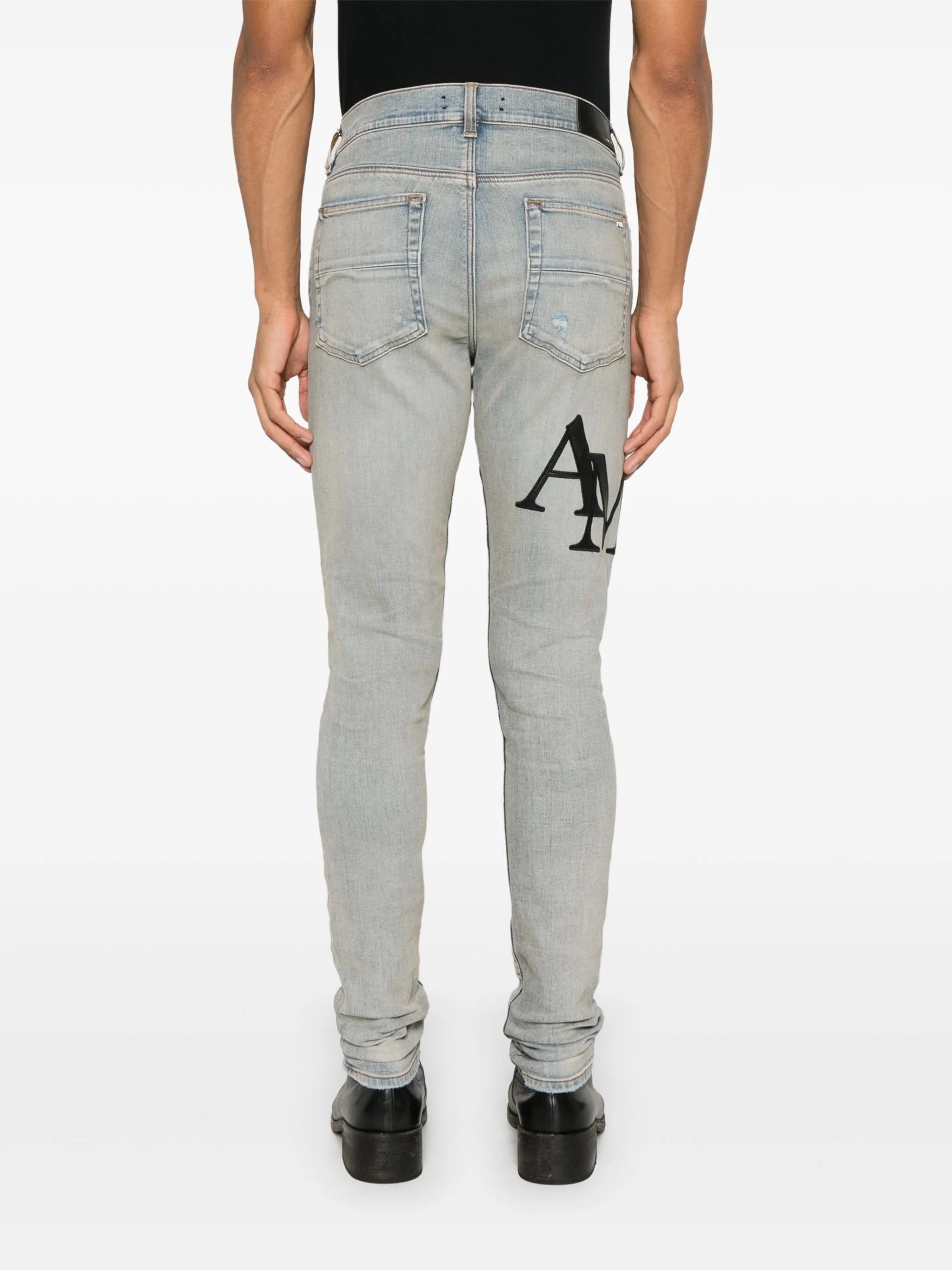 Staggered logo skinny jeans