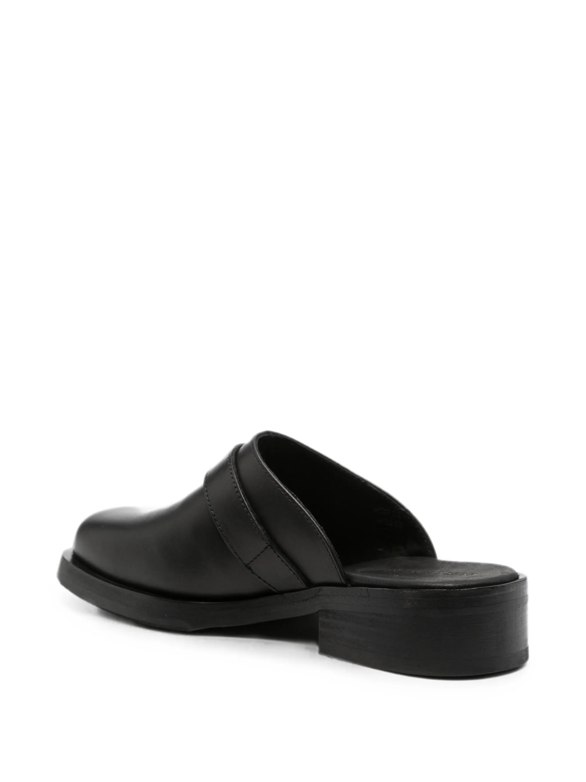 Camion mules in black leather